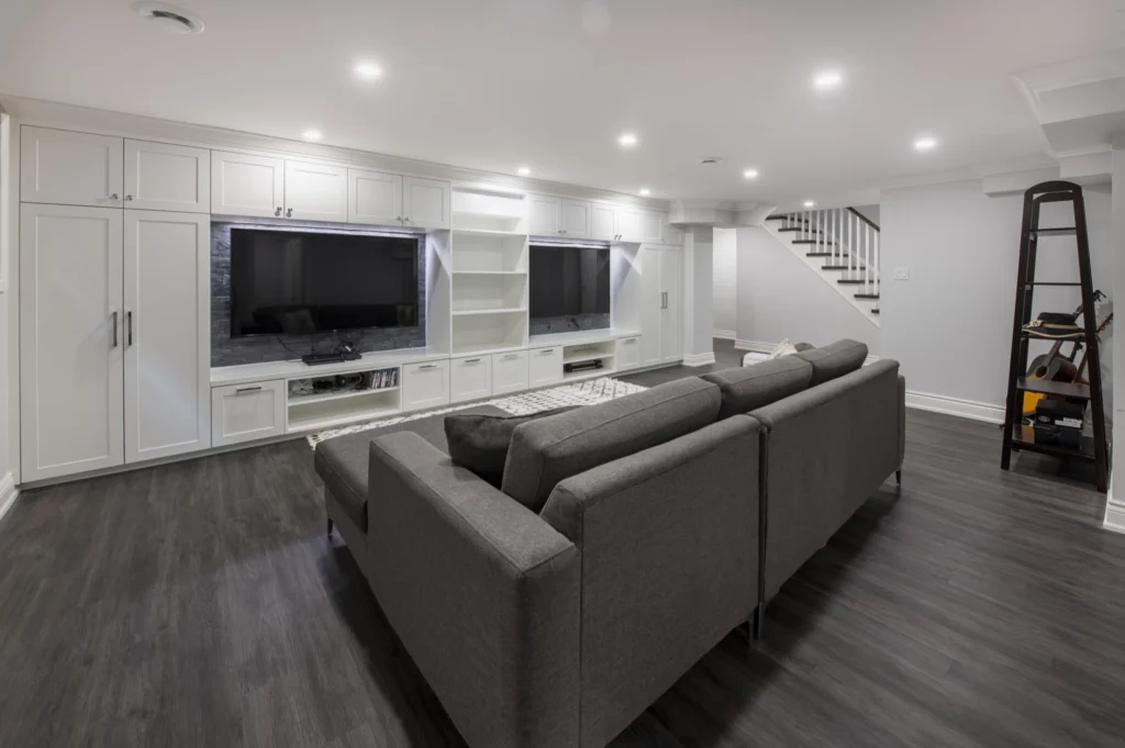 Basement Renovation Custom TV Unit White Custom Cabinets With Slate Stone Backsplash