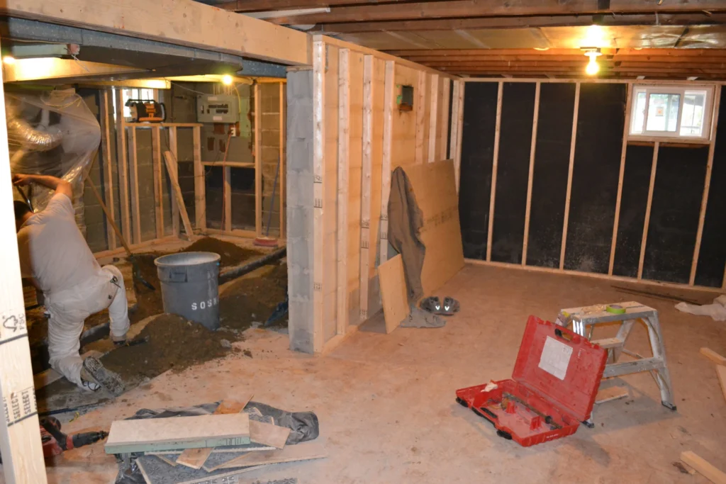Basement Renovation During Construction Worker Working On Drain Relocation GTA
