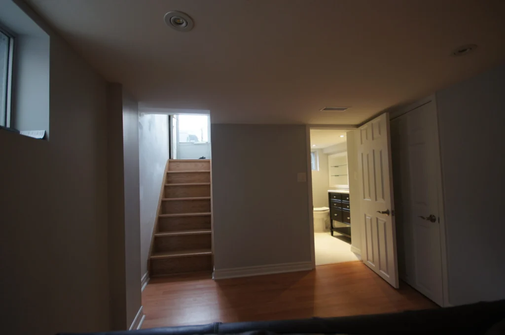 Dark Dated Basement Before Renovation Side Entry Door Remodeling