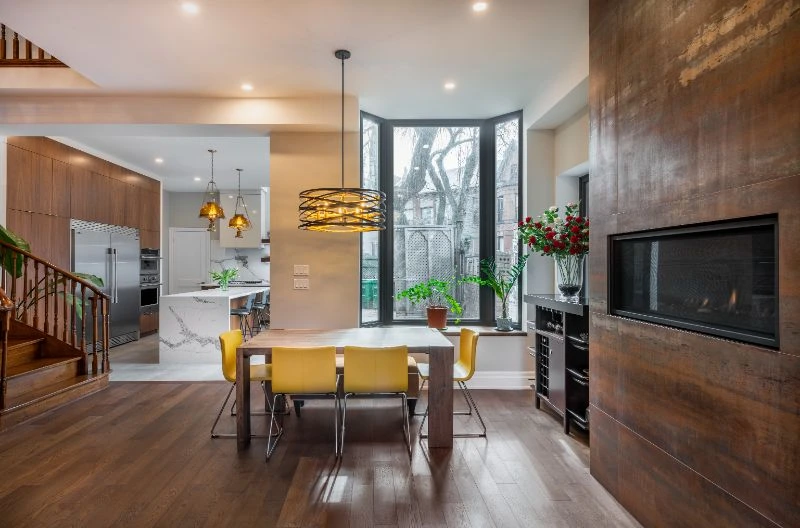 Dining Room And Kitchen Renovation With Matching Wood Fireplace Tile And Stained Hardwood With Wooden Cabinets