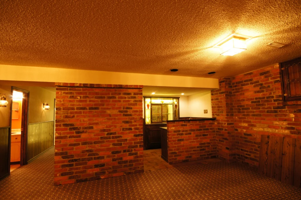 Exposed Brick Basement Renovation Before Dated Basement With Old Style Bar And Low Ceilings