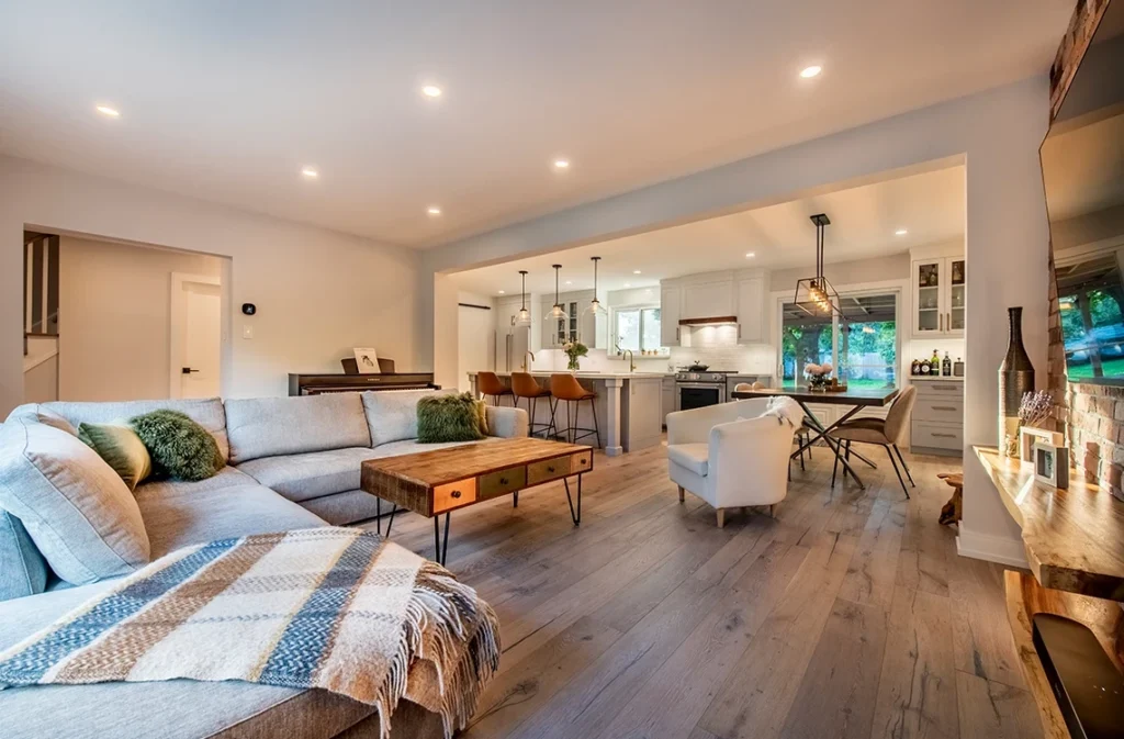 Open Concept Kitchen Renovation With White And Grey Cabinets And Wood Accents