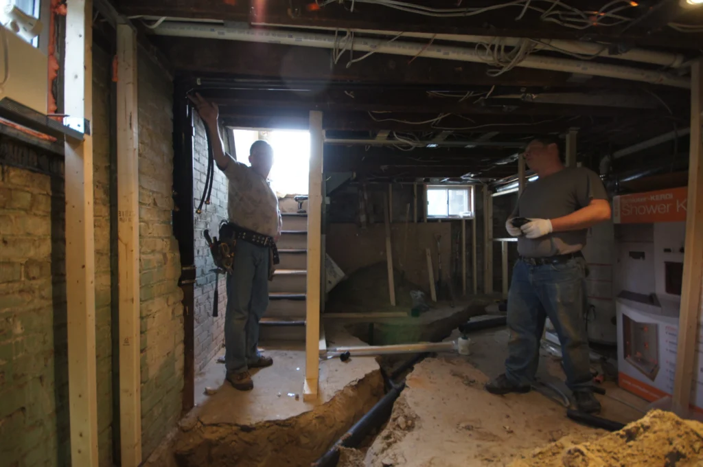 Project Manager And Site Leader Discussing On Construction Site GTA Home Renovators