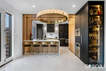 Black And Natural Wood Kitchen Cabinets With Gold Accents And Waterfall Wall Lights Luxury Renovation
