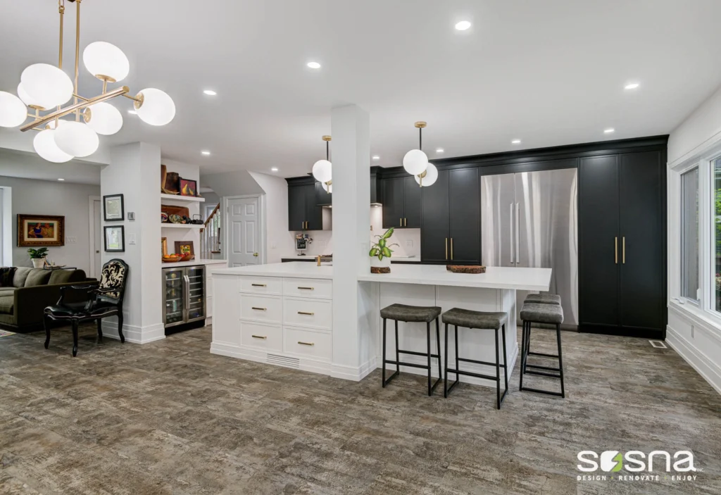 Black And White Kitchen Renovation With Gold Fixtures Large Island With Two-Sided Storage