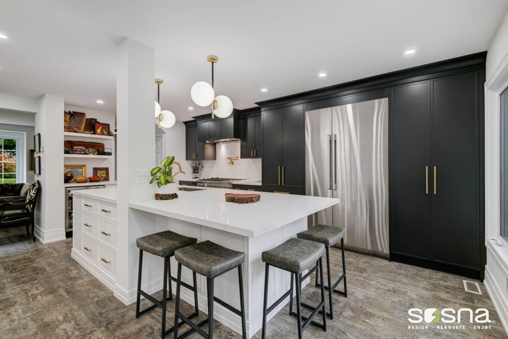 Open Concept Two-Tone Kitchen Black Cabinets White Island Gold Fixtures